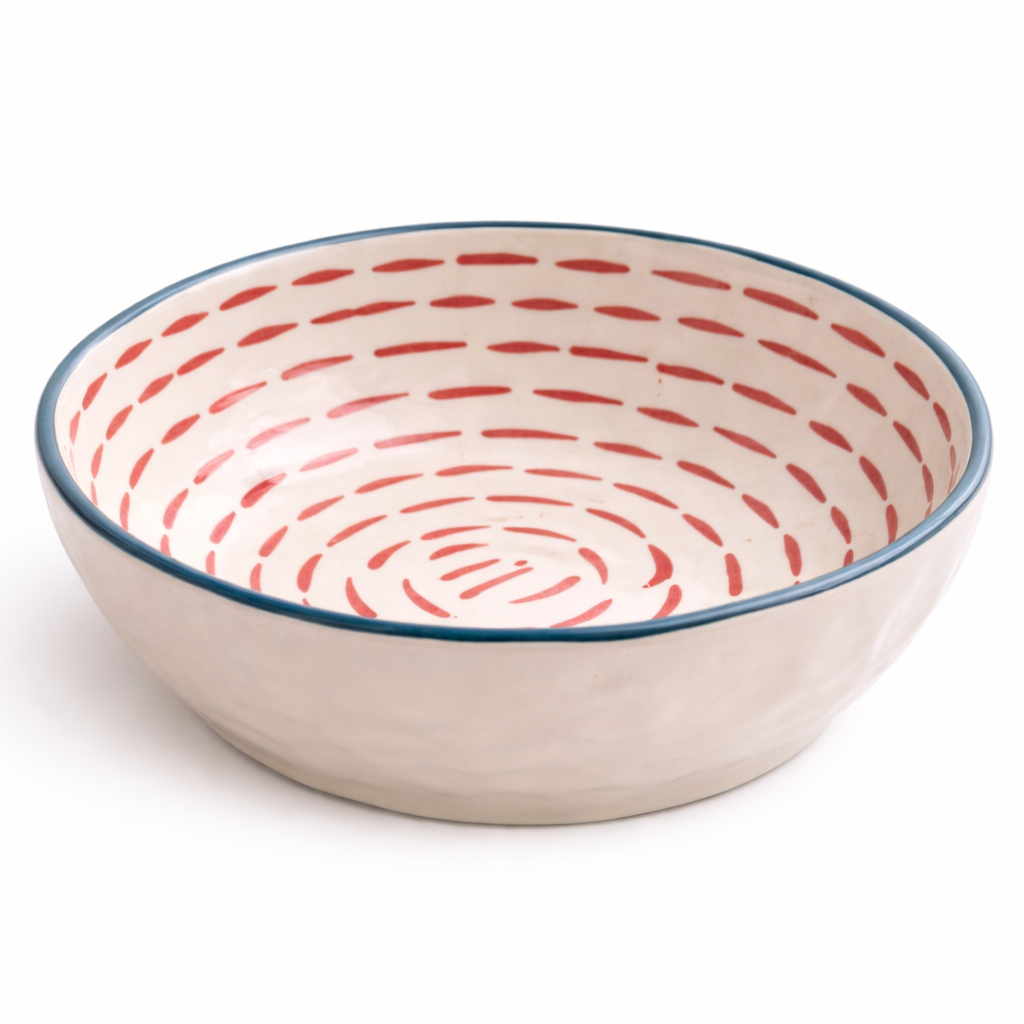 Ceramic bowl with red spiral pattern on a white background