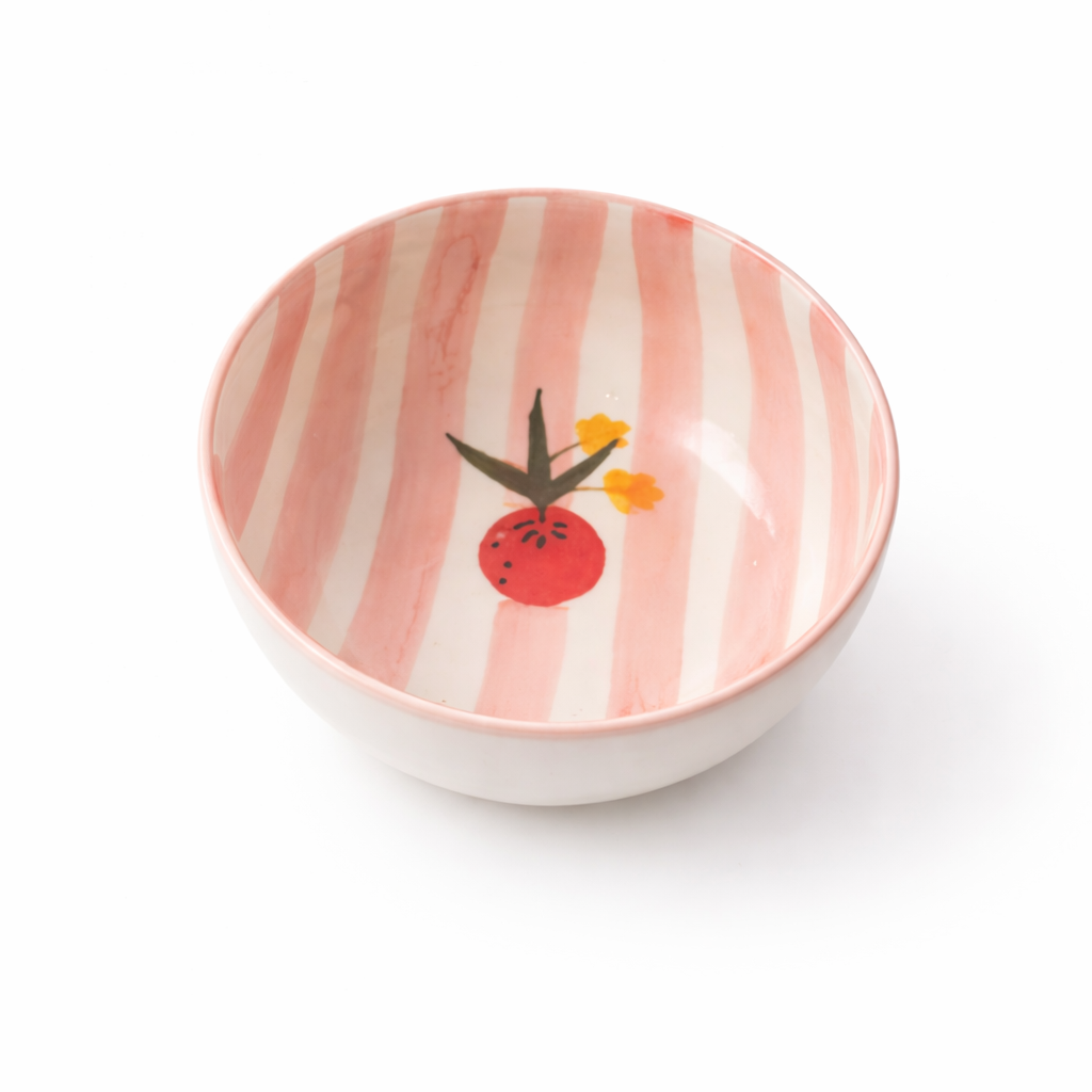 Small ceramic bowl with pink and white striped pattern and floral design on a white background