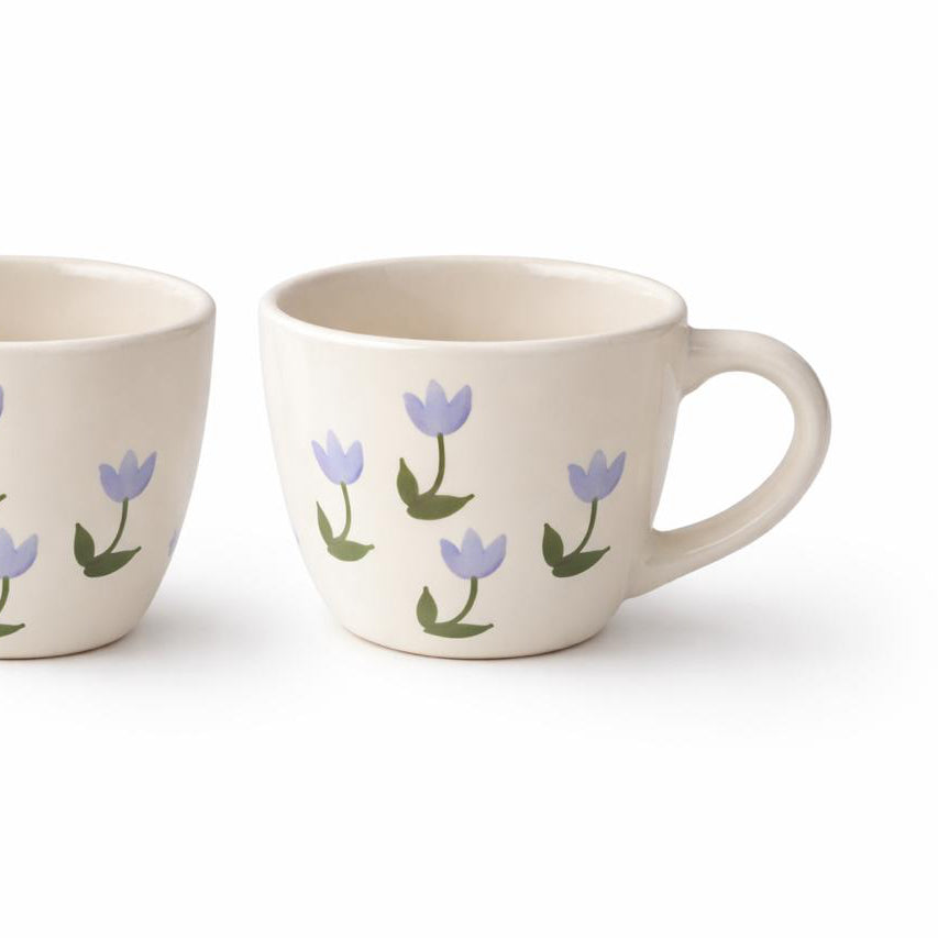 Two ceramic mugs with floral designs on a white background