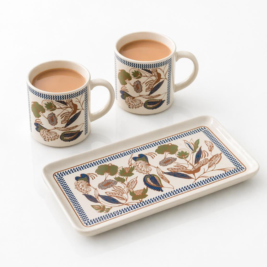 Two ceramic mugs and a tray with floral patterns on a white background