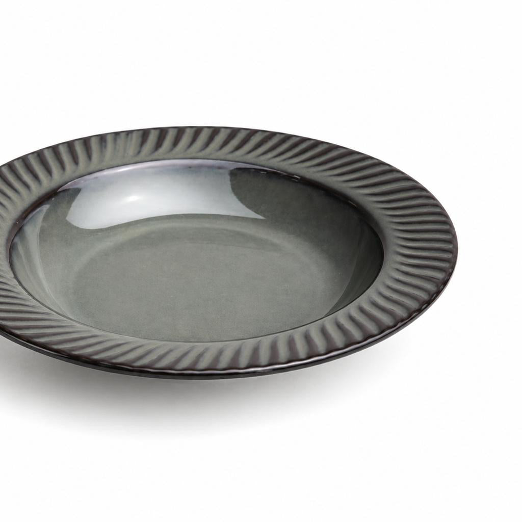 Gray ceramic plate with decorative rim on a white background