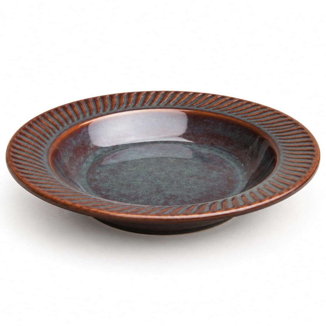 Ceramic bowl with ribbed edge on a white background