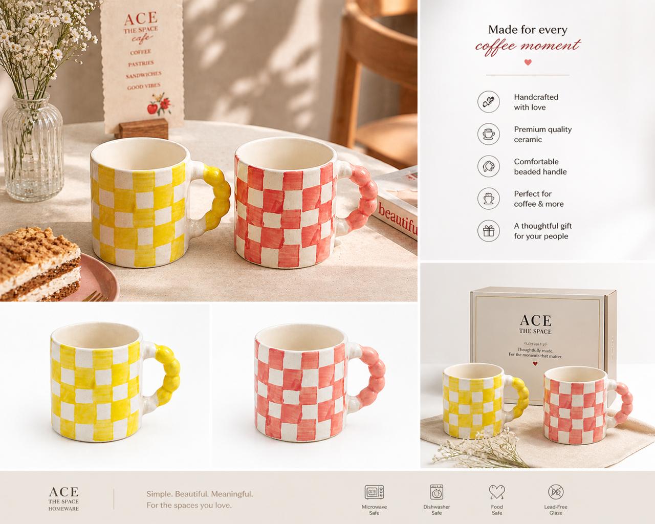 Two checkered mugs, one yellow and one pink, on a table with a box and cake in the background.