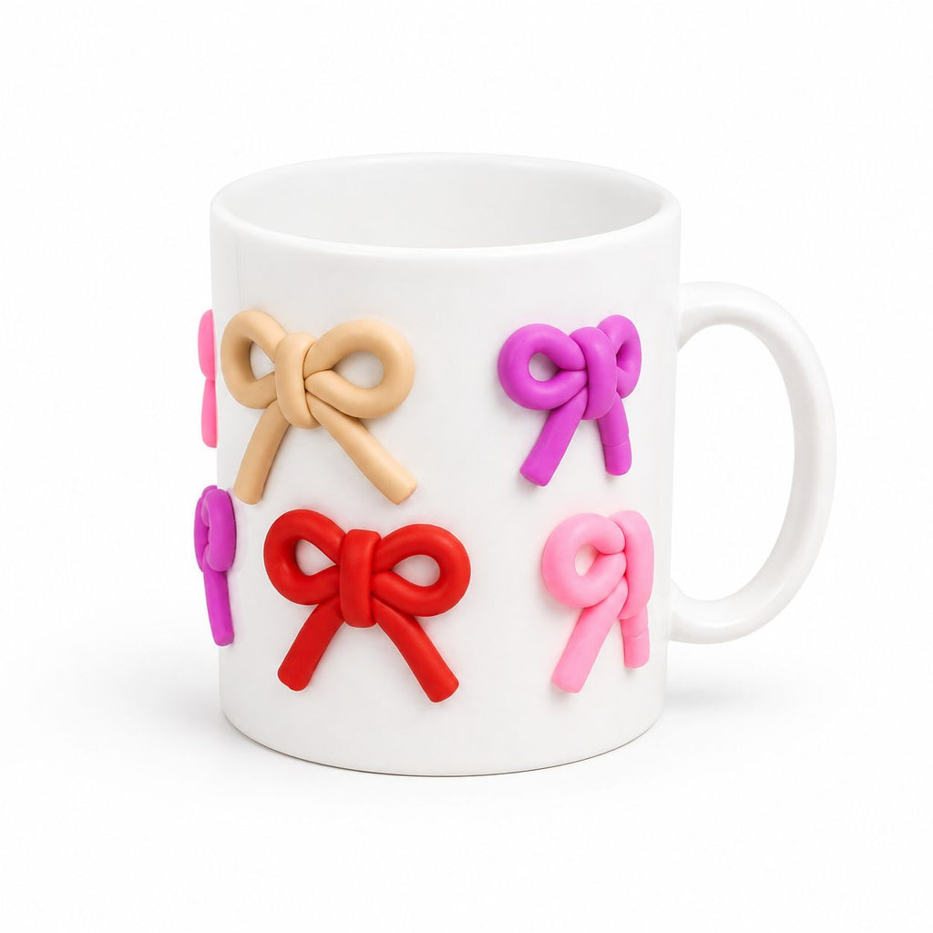 White mug with colorful bow-shaped decorations on a white background