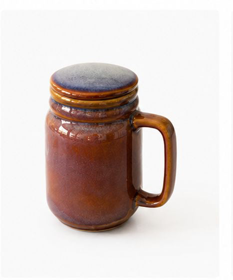 Collection of ceramic mugs with lids in various colors on a white background