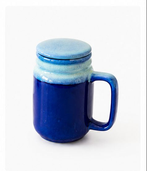 Collection of ceramic mugs with lids in various colors on a white background