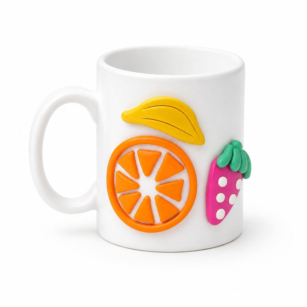 White mug with colorful fruit-shaped decorations on a white background