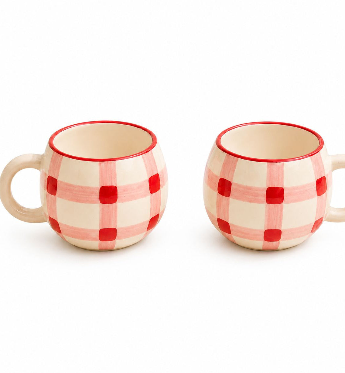 Two ceramic mugs with red checkered pattern on a white background