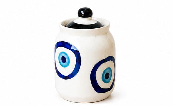 Set of colorful ceramic jars with decorative lids on a white background