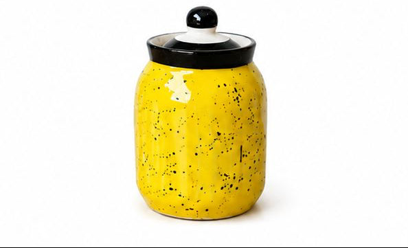 Set of colorful ceramic jars with decorative lids on a white background