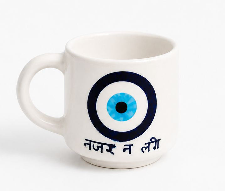 White mug and bowl with blue eye design and text on a white background