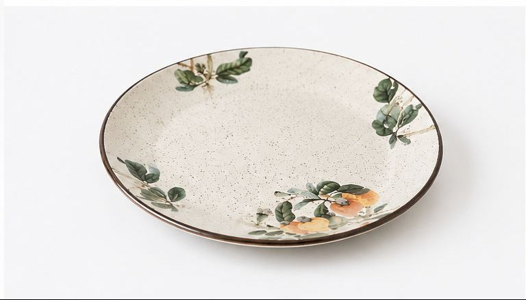 Set of ceramic dishes with floral and fruit design on a white background