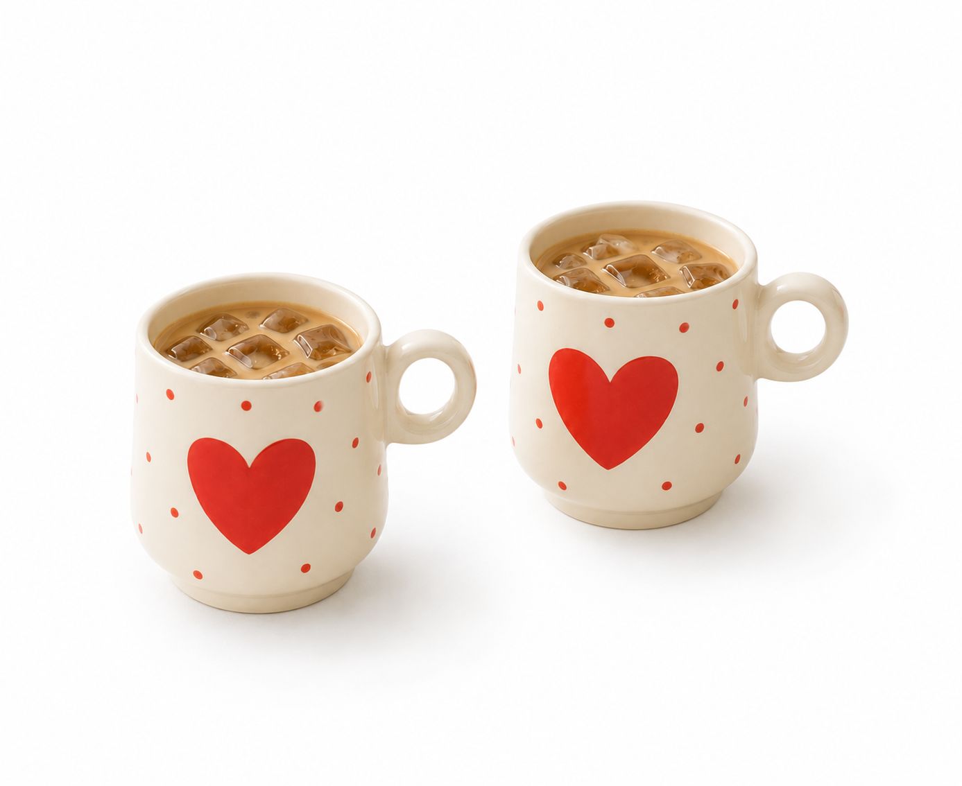 Two ceramic mugs with red heart designs on a white background