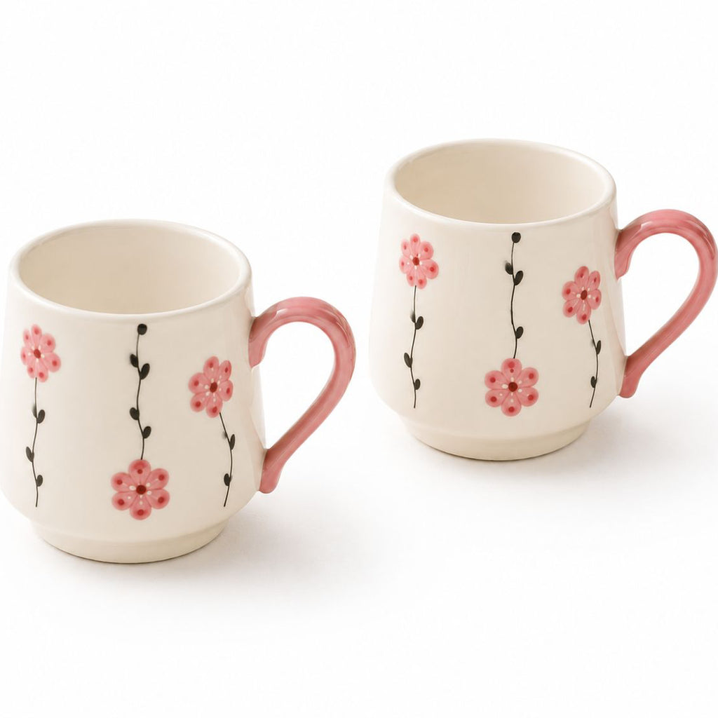 Two ceramic mugs with floral designs on a white background