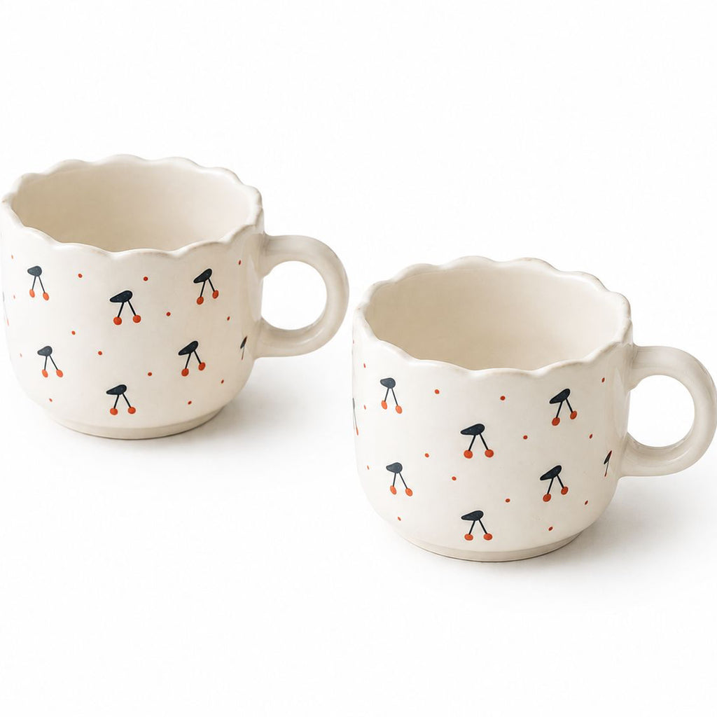Two ceramic mugs with decorative patterns on a white background