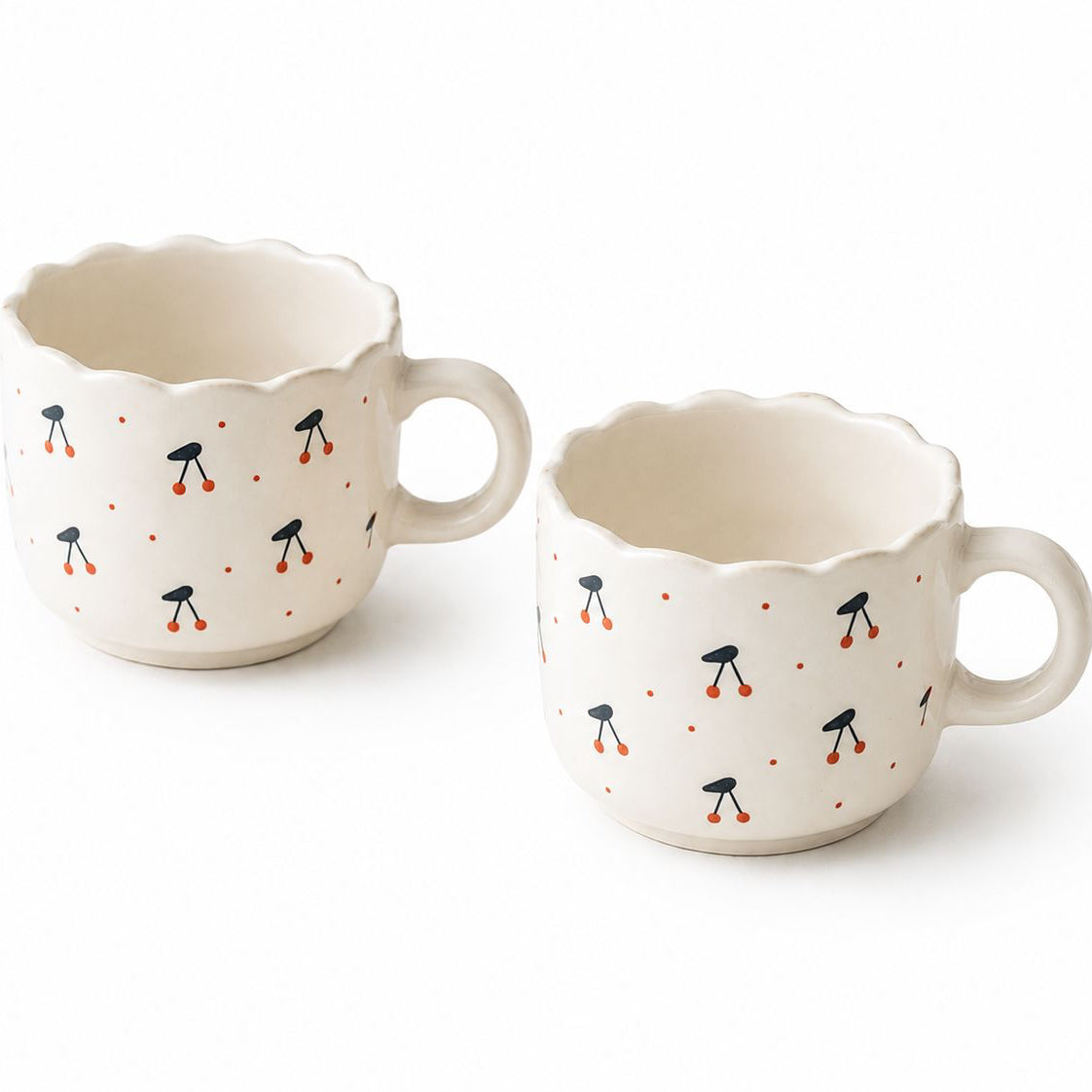 Two ceramic mugs with decorative patterns on a white background