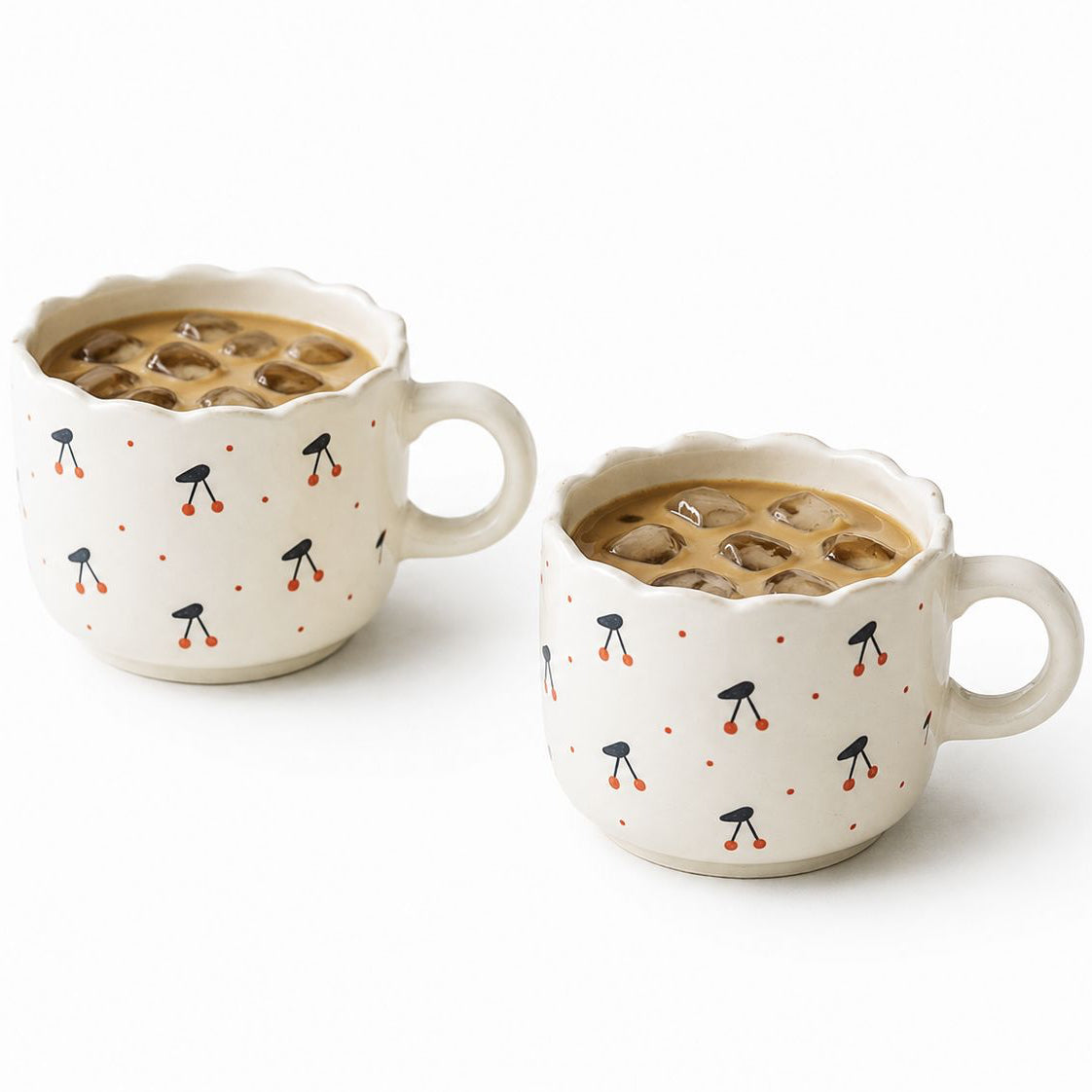 Two ceramic mugs with coffee and decorative patterns on a white background