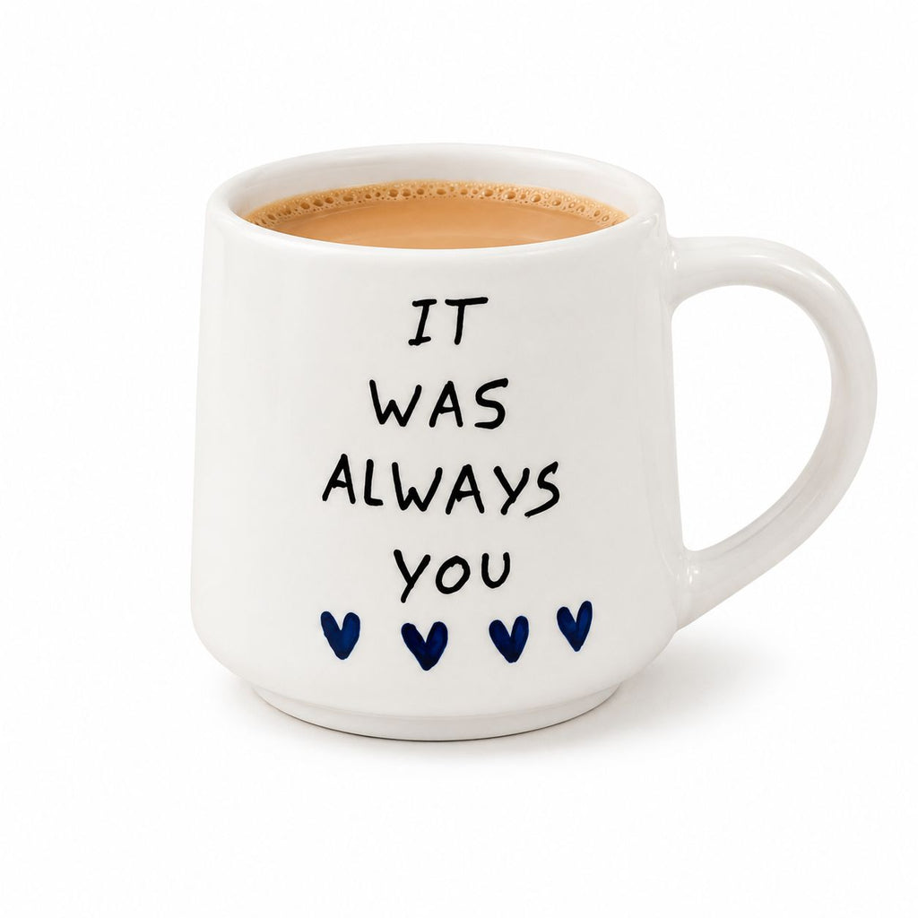 White mug with 'It was always you' text and heart shapes on a white background