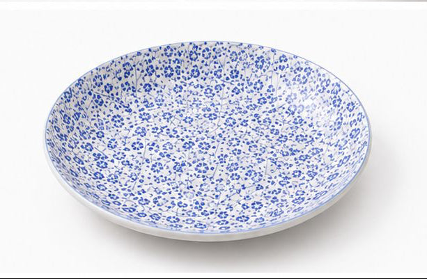 Set of blue floral-patterned ceramic dishes on a white background