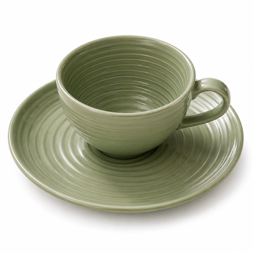 Green ceramic cup and saucer on a white background