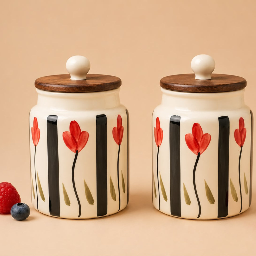 Two ceramic jars with floral design and wooden lids on a beige background