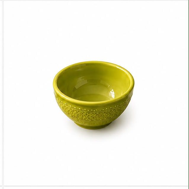 Set of green ceramic bowls and plates with decorative patterns on a white background