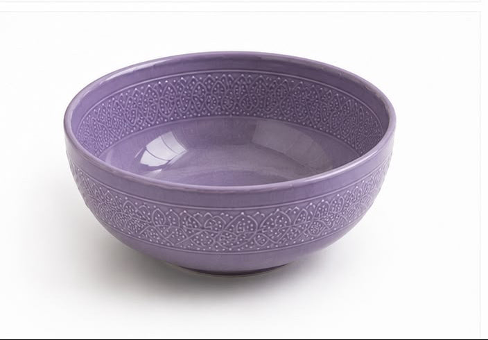 Set of purple ceramic dishes including bowls and plates on a white background